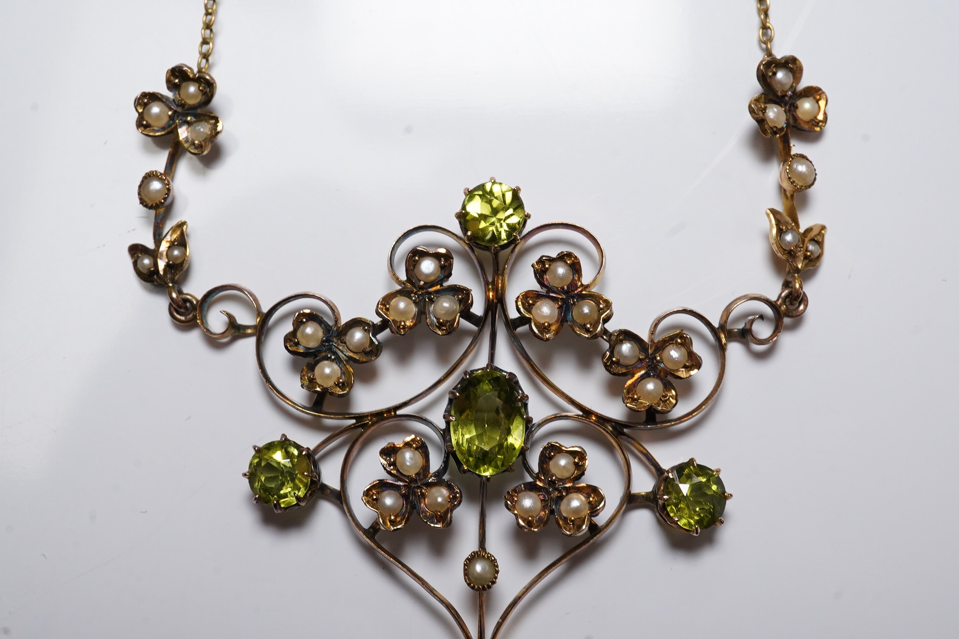 A late Victorian 9ct, peridot and seed pearl cluster set drop pendant necklace, 50cm, gross weight 5.7 grams. Condition - fair to good